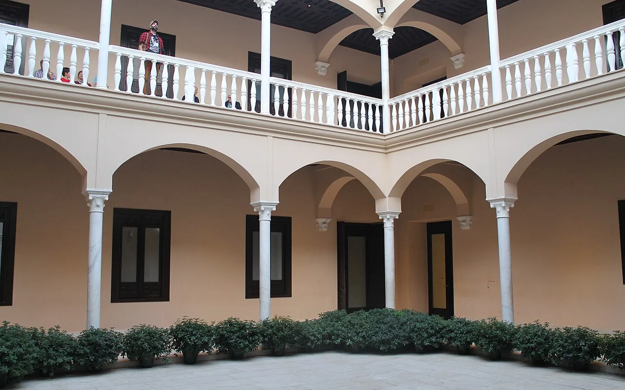Two-storey arcaded courtyard of the Palacio de Buenavista with clipped hedges, home of the Museo Picasso Málaga