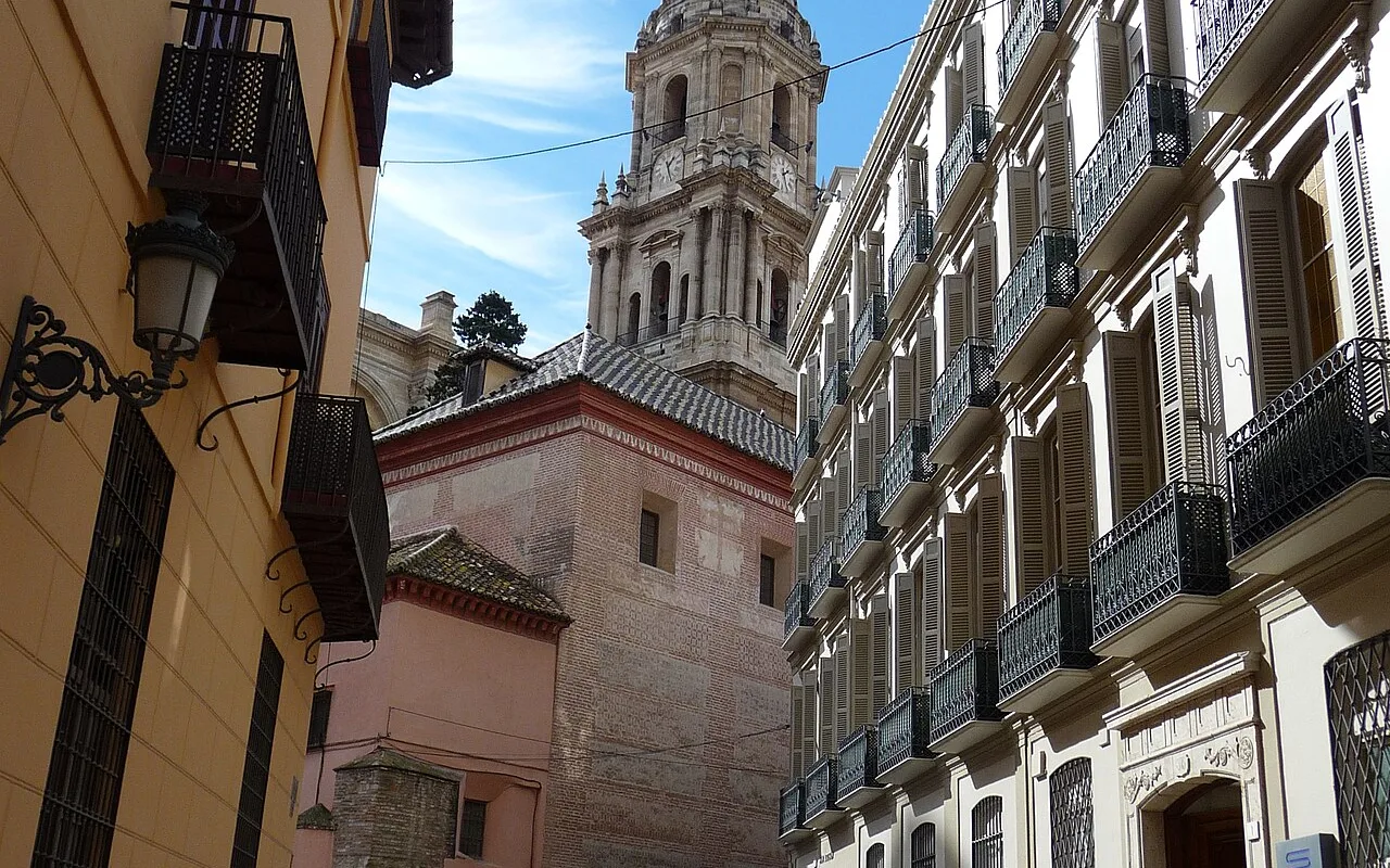 Calle San Agustín, the pedestrian lane beside the Museo Picasso Málaga, with the cathedral tower beyond